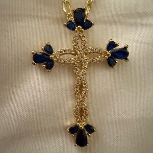Elegant Gold and Sapphire Twisting Cross Pendant Necklace